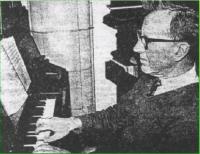 George Wainwright playing the organ, built in 1911 at a cost of £132 - click for full size image